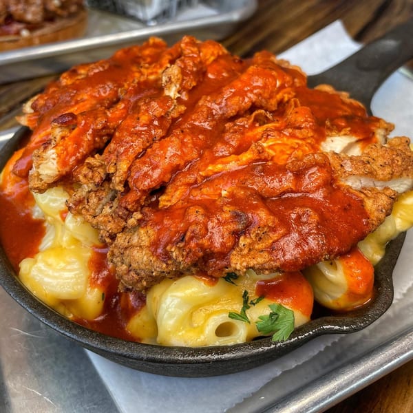 Vauxhall's spicy fried chicken and mac and cheese in a cast iron skillet.